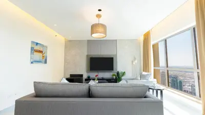 a living room with a couch and a tv at Regent Sea View 2BR Apartment JBR Beach Walk - next to Bluewater Island & Dubai Eye in Dubai