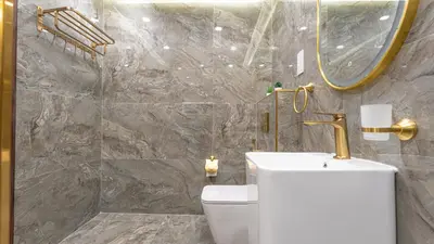 a bathroom with a toilet and a mirror at Regent Sea View 2BR Apartment JBR Beach Walk - next to Bluewater Island & Dubai Eye in Dubai