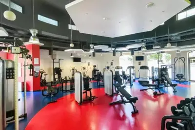 a gym with several treadmills and cardio machines at Regent Sea View 2BR Apartment JBR Beach Walk - next to Bluewater Island & Dubai Eye in Dubai