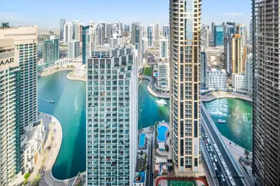an aerial view of a city with a river and buildings at Lovely 2-bed condo in JBR - 5 mins from beach - Palm View! in Dubai