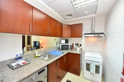 a kitchen with a sink and a microwave at Luxury Escapes - Studio in JLT X1 Tower close to Metro in Dubai