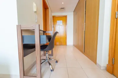 an office with a desk and a chair in a hallway at Luxury Escapes - Budget Studio Apt near Metro Stn - MOG184 DG in Dubai