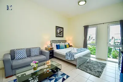 a living room with a bed and a couch at Luxury Escapes - Cozy budget studio near Metro & Ibn Battuta Mall - MOG190 DG in Dubai