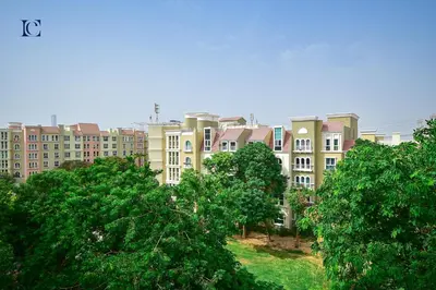 a group of buildings with trees in the foreground at Luxury Escapes - Cozy budget studio near Metro & Ibn Battuta Mall - MOG190 DG in Dubai