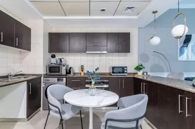 a kitchen with a white table and chairs at GuestReady - Elegant 1BR w/ Balcony | Dubai Marina in Dubai
