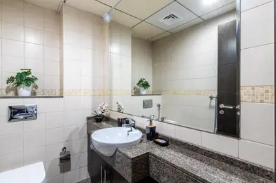 a bathroom with a sink and a mirror at GuestReady - Elegant 1BR w/ Balcony | Dubai Marina in Dubai