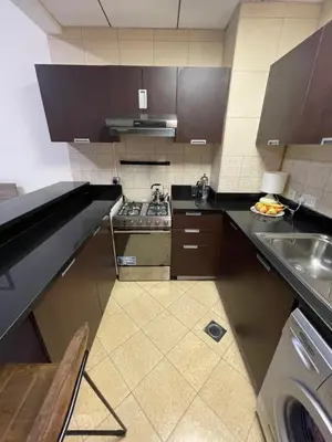 a small kitchen with a sink and a stove at Big studio, Dubai SportCity, parking included in Dubai