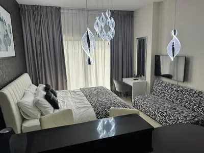 a hotel room with a bed and a couch at Big studio, Dubai SportCity, parking included in Dubai