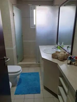 a bathroom with a sink and a toilet and a mirror at Cherrywood House in Dubai