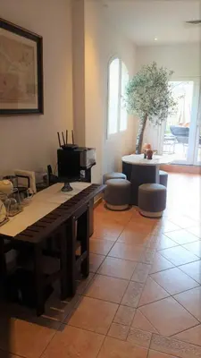 a living room with a table and a piano at Cherrywood House in Dubai