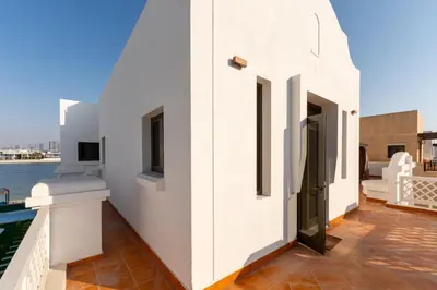 a white house with a view of the water at Palm Jumeirah - Property Advisers in Dubai