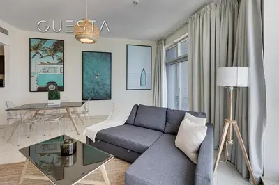 a living room with a couch and a table at The Torch, Dubai Marina in Dubai