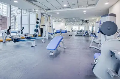 a gym with treadmills and machines in a building at The Torch, Dubai Marina in Dubai