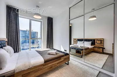 a bedroom with two beds and a large window at The Torch, Dubai Marina in Dubai
