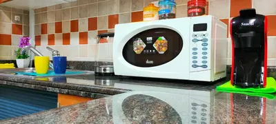 a microwave oven sitting on a counter in a kitchen at 2 BR apartment with a beautiful view of the Marina minimum 5 night in Dubai