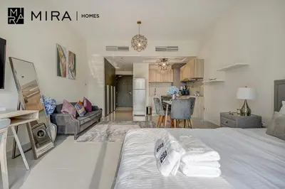 a large room with a bed and a kitchen at Mira Holiday Homes - Lovely Studio in AG tower with free parking in Dubai