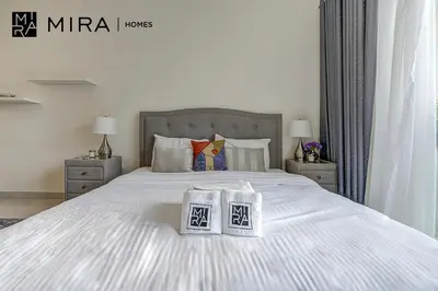 a bedroom with a bed with two bags on it at Mira Holiday Homes - Lovely Studio in AG tower with free parking in Dubai