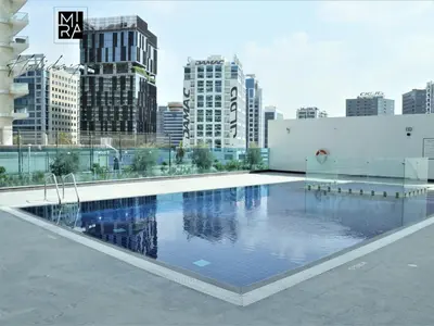 a large swimming pool on the roof of a building at Mira Holiday Homes - Lovely Studio in AG tower with free parking in Dubai