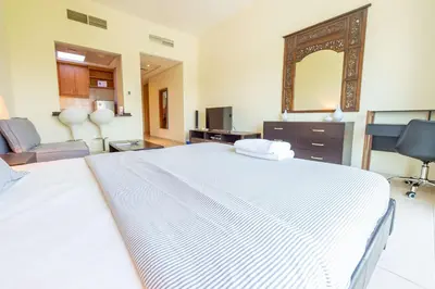 a bedroom with a large white bed and a mirror at Luxury Escapes - Stylish Studio in DG near to Mall & Metro - KSLV in Dubai