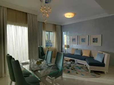 a living room with a glass table and a couch at DAMAC Maison Mall Street in Dubai