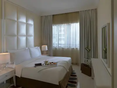 a hotel room with a large bed and a window at DAMAC Maison Mall Street in Dubai