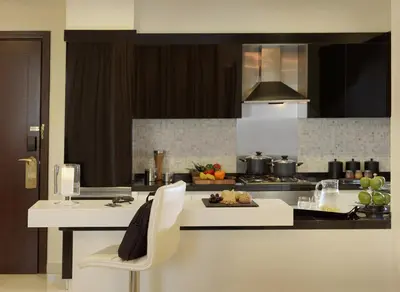 a kitchen with a white counter and a stove at DAMAC Maison Mall Street in Dubai