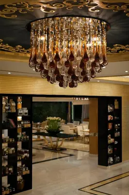 a chandelier hanging from the ceiling in a restaurant at DAMAC Maison Mall Street in Dubai