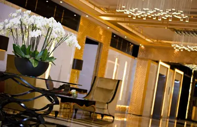 a lobby with a table and a vase of flowers at DAMAC Maison Mall Street in Dubai