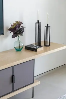 a table with two candles and a vase with flowers at Frank Porter - The Address JBR in Dubai
