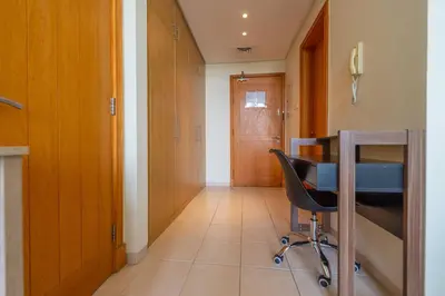 a hallway with a desk and a chair at Luxury Escapes - Tranquil Retreat - Studio Apts near Metro and Mall - Discovery Gardens - SHAR & MCL in Dubai