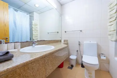 a bathroom with a sink and a toilet at Luxury Escapes - Tranquil Retreat - Studio Apts near Metro and Mall - Discovery Gardens - SHAR & MCL in Dubai