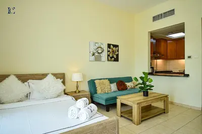 a living room with a couch and a table at Luxury Escapes - Tranquil Retreat - Studio Apts near Metro and Mall - Discovery Gardens - SHAR & MCL in Dubai