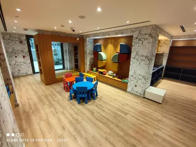 a classroom with a table and chairs in a room at Notable 2BR at Sobha Hartland Greens MBR City by Deluxe Holiday Homes in Dubai