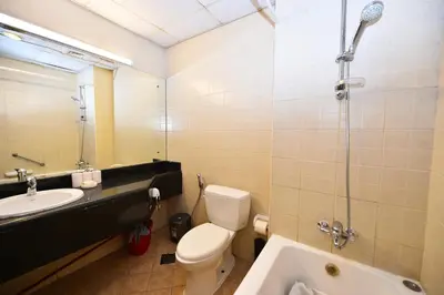 a bathroom with a toilet and a sink and a shower at Luxury Escapes - Budget Studio with Garden Views near Metro - MED64 DG in Dubai