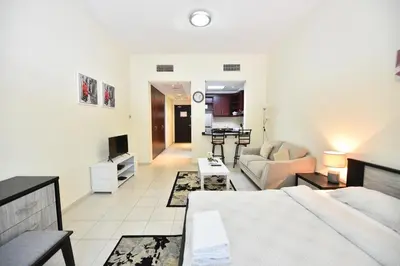 a living room with a bed and a couch at Luxury Escapes - Budget Studio with Garden Views near Metro - MED64 DG in Dubai