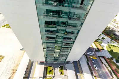 an aerial view of a tall glass building at Deluxe One Bedroom Apartment for rent in Dubai Al Barsha south in Dubai
