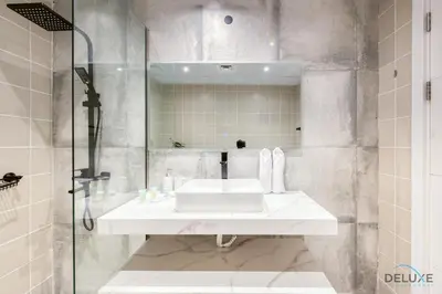 a bathroom with a sink and a mirror at Elegant 2BR at The Point Dubai Marina by Deluxe Holiday Homes in Dubai