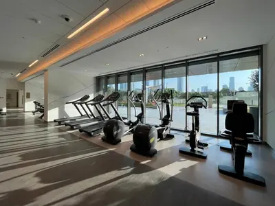a gym with treadmills and ellipticals in a building at GuestReady - The Ivory Coast Downtown Views in Dubai