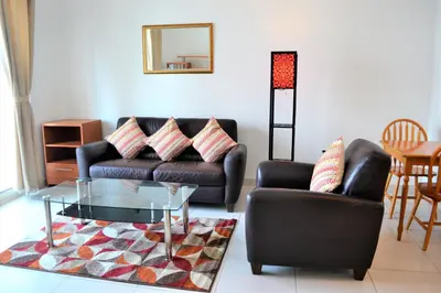a living room with a leather couch and a glass table at Luxury Escapes - 1BR with Balcony & Stunning Marina View - MVT in Dubai