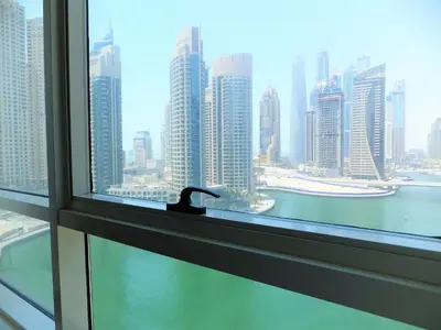 a window with a view of a city skyline at Luxury Escapes - 1BR with Balcony & Stunning Marina View - MVT in Dubai