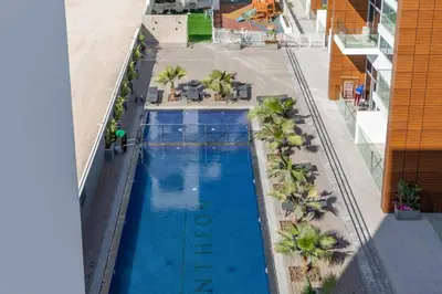 an overhead view of a swimming pool on a building at Modern 1BR in Jumeirah Village Circle (Pool View) in Dubai