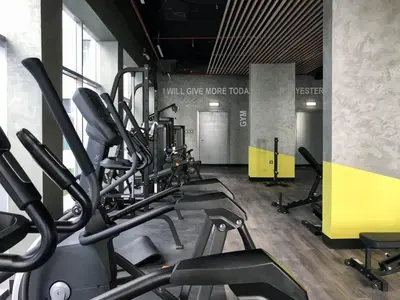 a gym with treadmills and ellipticals in a room at Modern 1BR in Jumeirah Village Circle (Pool View) in Dubai