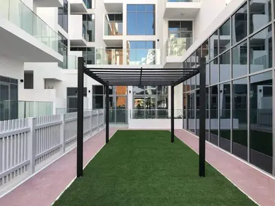 a walkway in the middle of a building at Modern 1BR in Jumeirah Village Circle (Pool View) in Dubai
