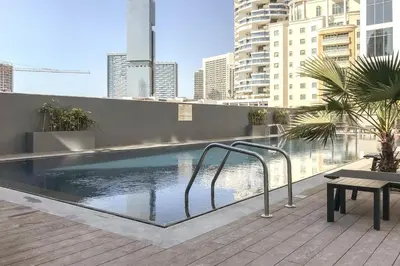 a swimming pool on the roof of a building at Modern 1BR in Jumeirah Village Circle (Pool View) in Dubai