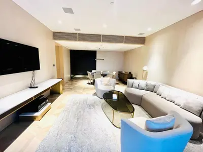 a living room with a couch and a tv at FIVE Palm Jumeirah - 2 Bedrooms & Maid Room Apartment in a Splendid Resort in Dubai