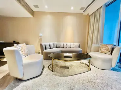 a living room with two chairs and a coffee table at FIVE Palm Jumeirah - 2 Bedrooms & Maid Room Apartment in a Splendid Resort in Dubai