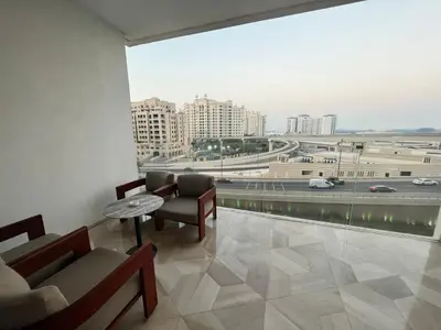 a room with a table and chairs and a large window at FIVE Palm Jumeirah - 2 Bedrooms & Maid Room Apartment in a Splendid Resort in Dubai