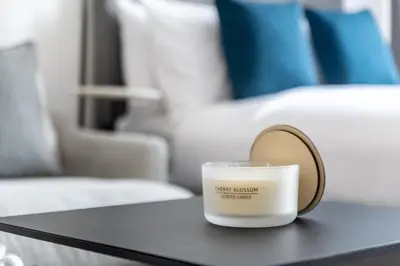a candle sitting on a table in a room at Silkhaus elegant studio in the central DIFC with balcony and city views in Dubai