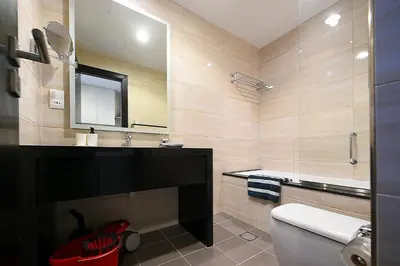 a bathroom with a toilet and a sink and a mirror at Luxury Escapes - Quiet Studio near Expo City and DWC Airport - CELESTIA TOWER in Dubai
