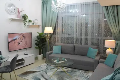 a living room with a couch and a tv at Newly furnished One Bedroom Apartment next to Metro & Beach in Marina Residence in Dubai